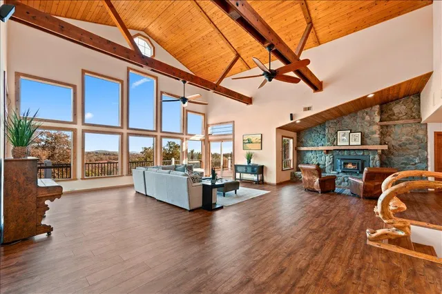 a kitchen with stainless steel appliances granite countertop wooden floors stove top oven and microwave