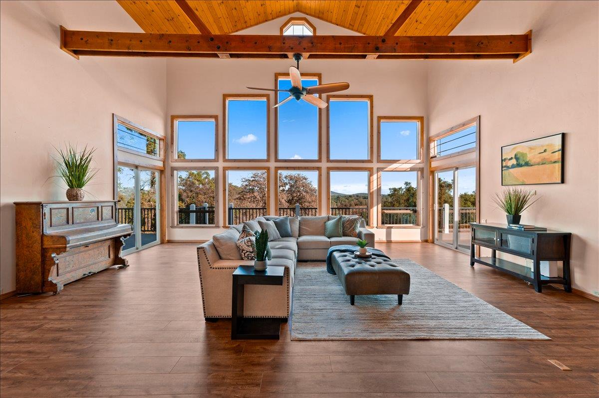 16000 Southridge Road Penn Valley, CA 95946 - Photo 10 of 75 a living room with furniture a rug potted plant and a large window