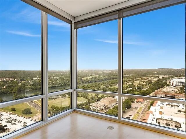 300 Bowie Street, Unit 2504 Austin, TX 78703 - Photo 1 of 10 Unfurnished sunroom featuring a wall of windows and a view of city