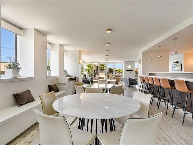 300 Bowie Street, Unit 2504 Austin, TX 78703 - Photo 9 of 10 Dining room featuring light wood finished floors and floor to ceiling windows
