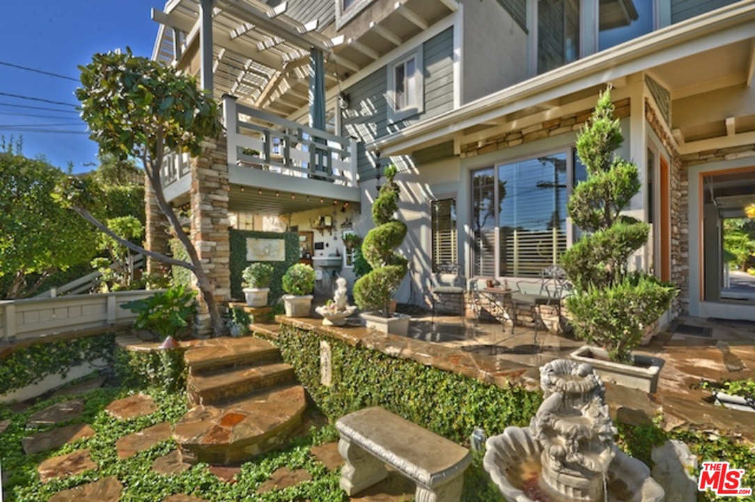 15098 Rayneta Drive Sherman Oaks, CA 91403 - Photo 11 of 51 a view of a chairs and table in a backyard