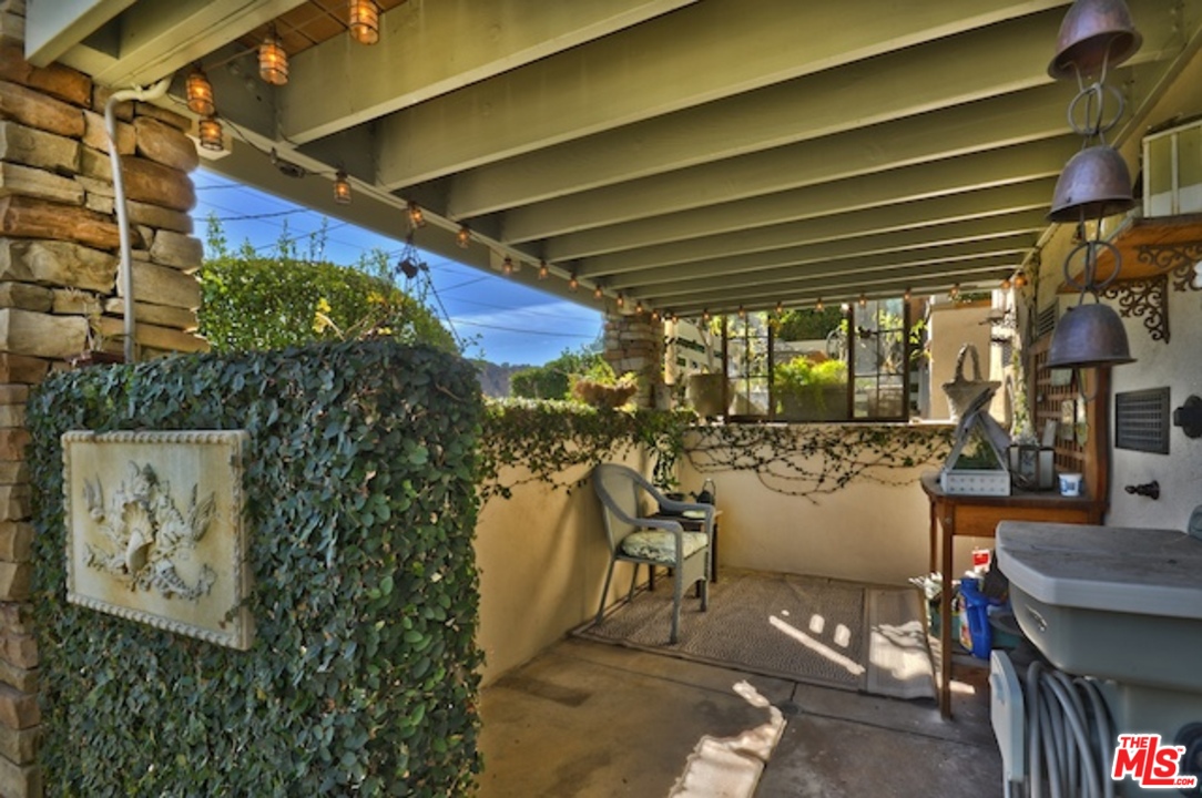 15098 Rayneta Drive Sherman Oaks, CA 91403 - Photo 14 of 51 a view of a porch with table and chairs and potted plants