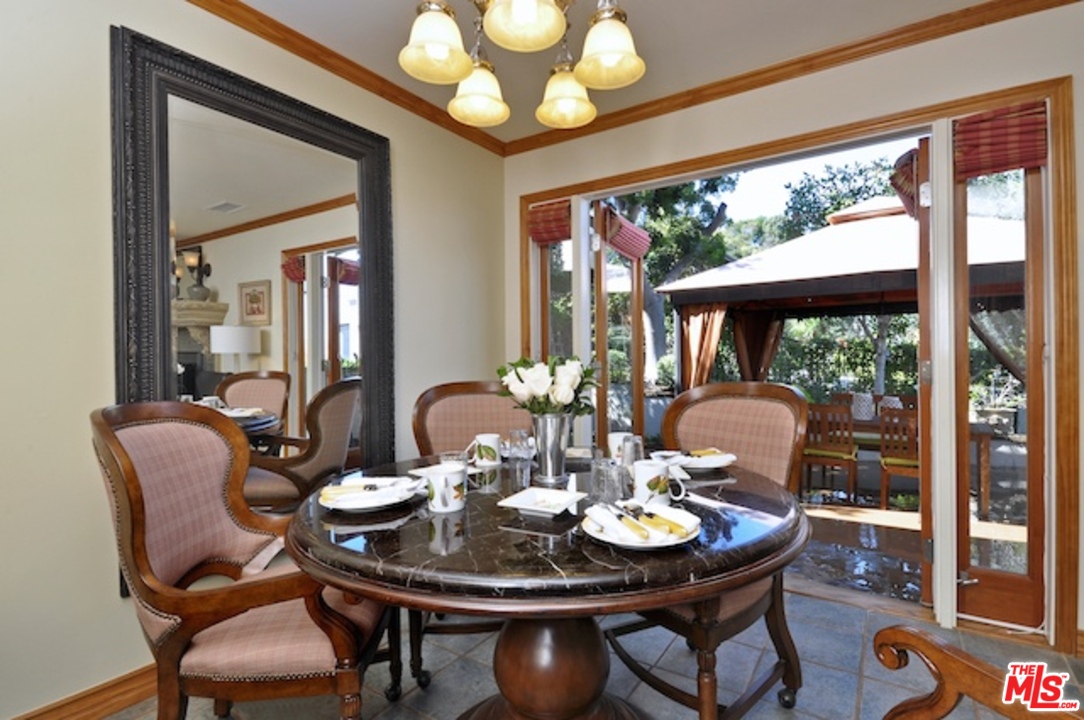 15098 Rayneta Drive Sherman Oaks, CA 91403 - Photo 19 of 51 a view of a dining room with furniture wooden floor and chandelier