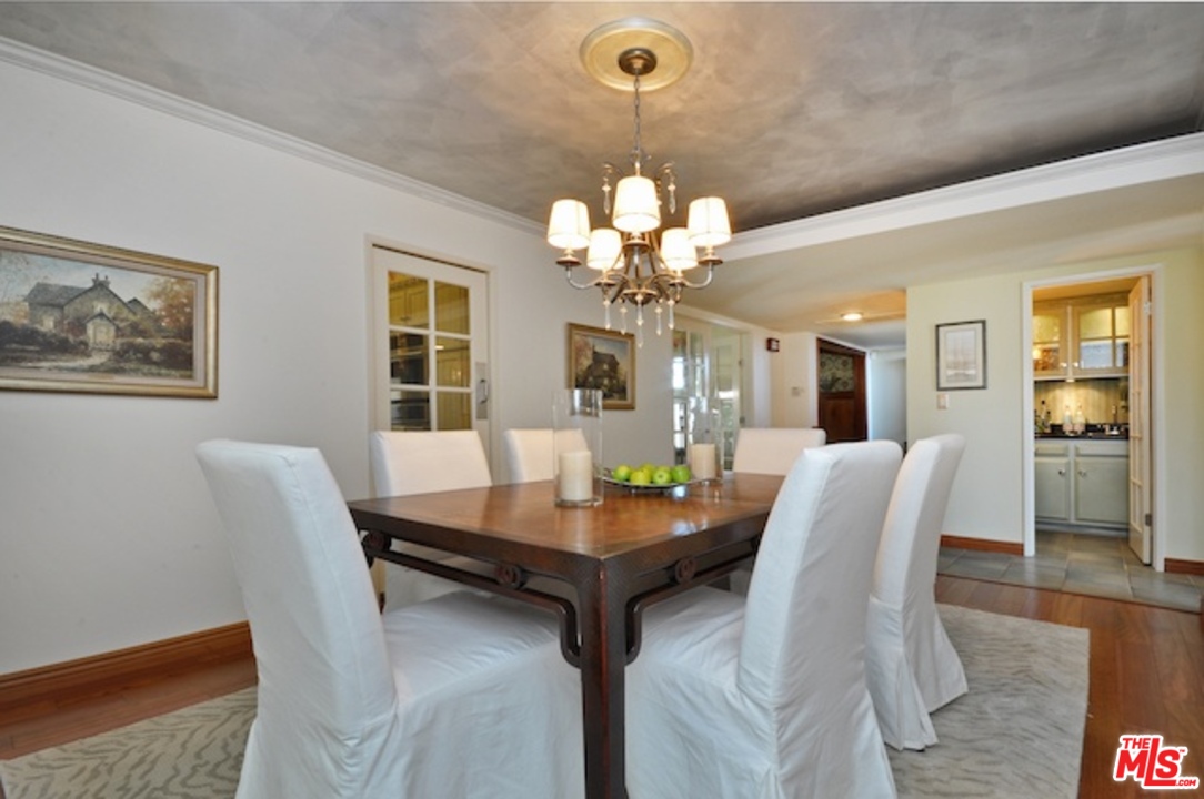 15098 Rayneta Drive Sherman Oaks, CA 91403 - Photo 22 of 51 a dining room with furniture and chandelier