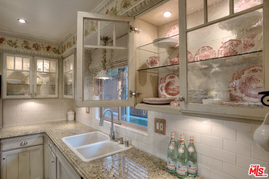 15098 Rayneta Drive Sherman Oaks, CA 91403 - Photo 25 of 51 a bathroom with a sink and a mirror