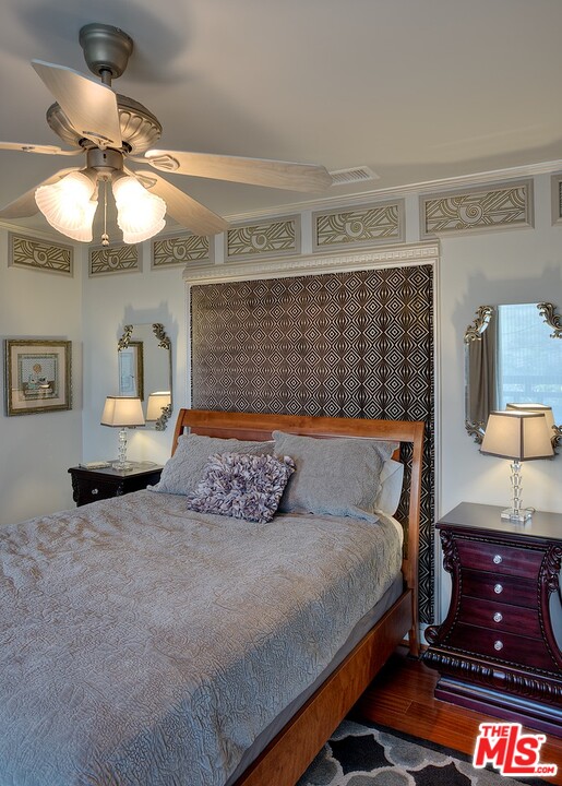 15098 Rayneta Drive Sherman Oaks, CA 91403 - Photo 28 of 51 a bedroom with a bed and lamp on dresser