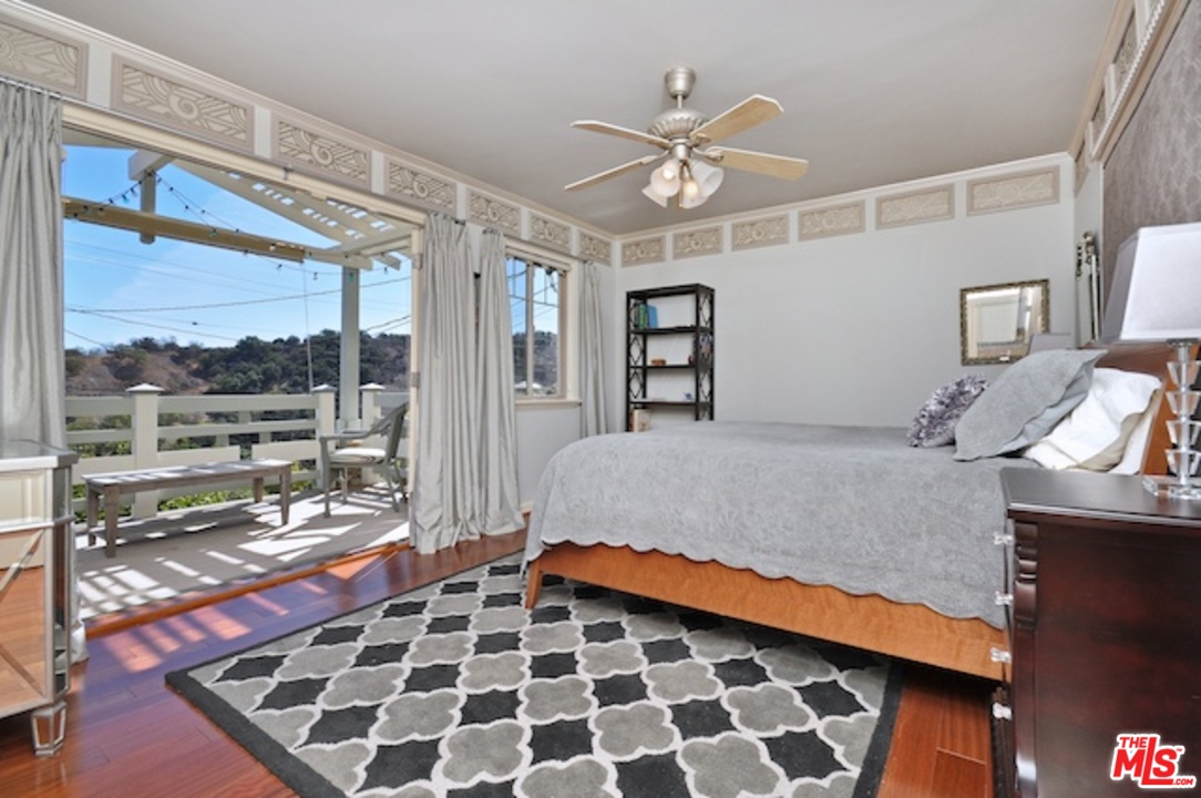 15098 Rayneta Drive Sherman Oaks, CA 91403 - Photo 30 of 51 a bedroom with a bed and glass window