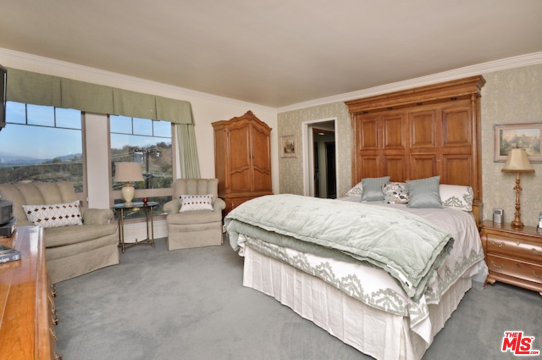 15098 Rayneta Drive Sherman Oaks, CA 91403 - Photo 39 of 51 a large bed sitting in a bedroom next to a window