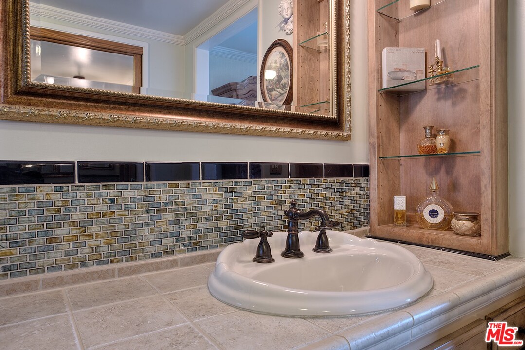 15098 Rayneta Drive Sherman Oaks, CA 91403 - Photo 40 of 51 a bathroom with a sink a mirror and bathtub