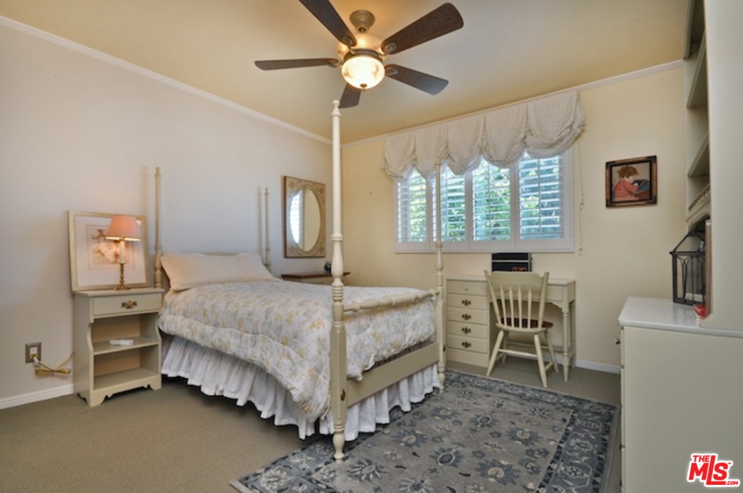 15098 Rayneta Drive Sherman Oaks, CA 91403 - Photo 42 of 51 a bedroom with a bed and a chandelier