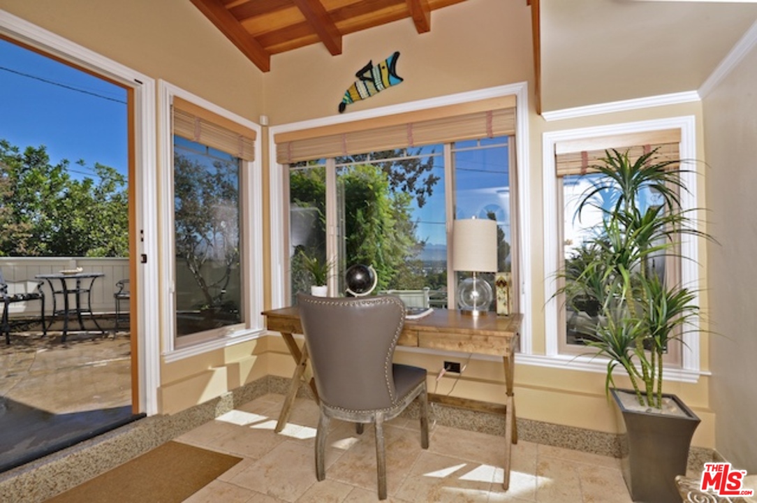 15098 Rayneta Drive Sherman Oaks, CA 91403 - Photo 44 of 51 a view of a patio with table and chairs potted plants and floor to ceiling window