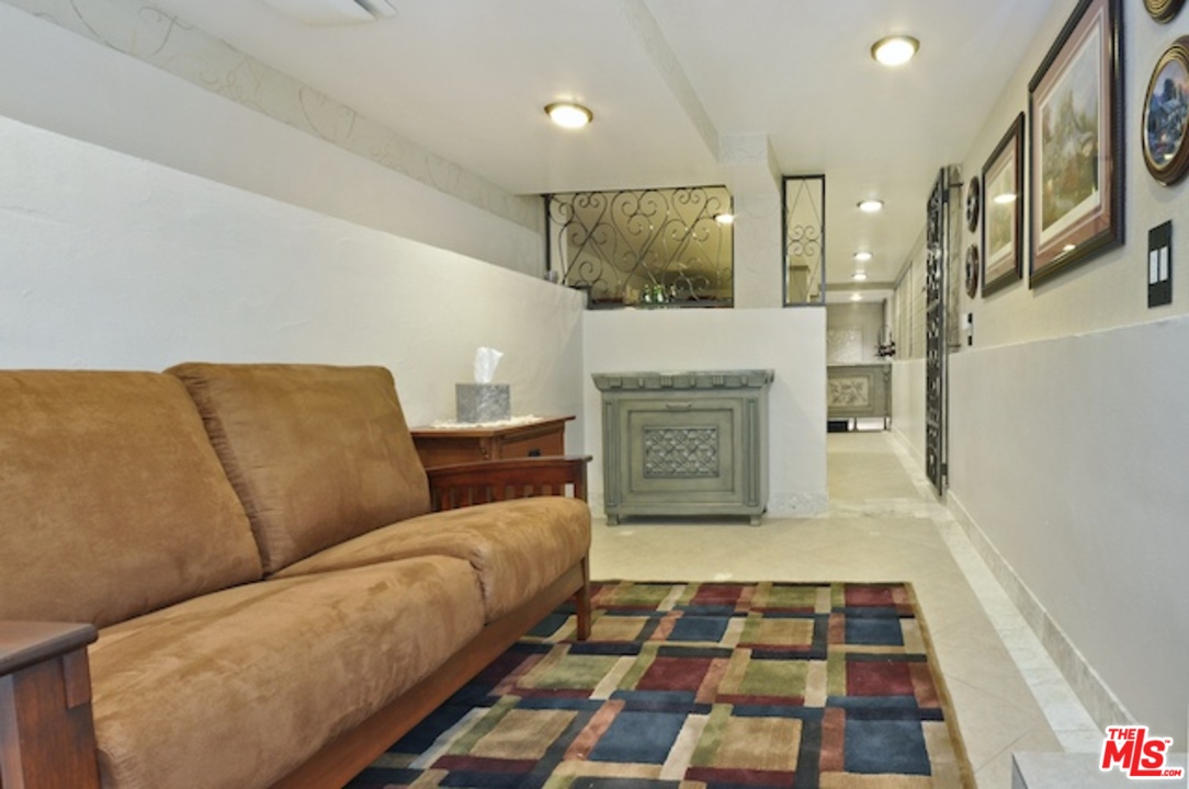 15098 Rayneta Drive Sherman Oaks, CA 91403 - Photo 50 of 51 a living room with furniture and a rug