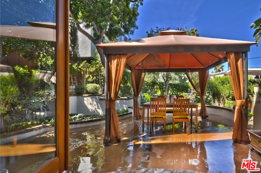 15098 Rayneta Drive Sherman Oaks, CA 91403 - Photo 8 of 51 a patio with a yard table and chairs