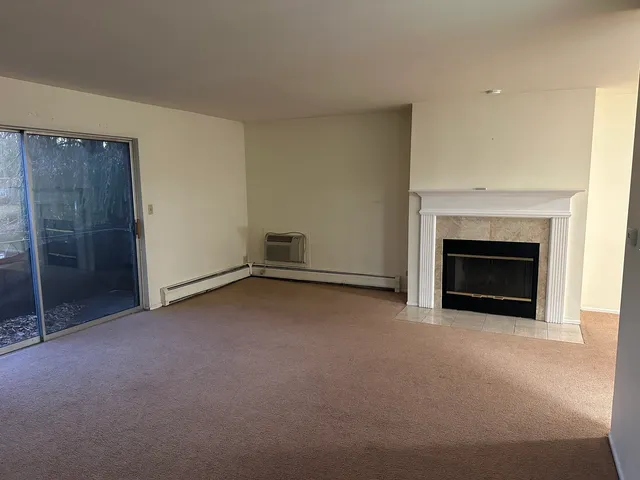 a view of empty room with a fireplace
