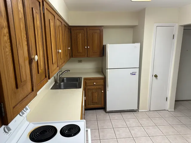a kitchen with a refrigerator and a stove