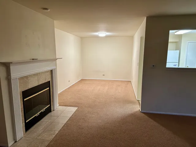 a view of an empty room with a fireplace