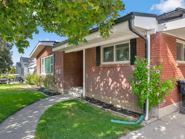 523 South Main Street Payson, UT 84651 - Photo 6 of 41 Brick exterior featuring a covered entry, concrete walkway, and established landscaping