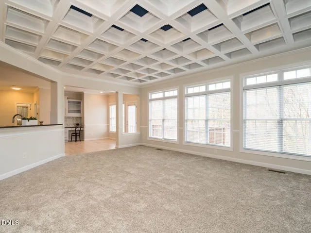 an empty room with a kitchen and a sink