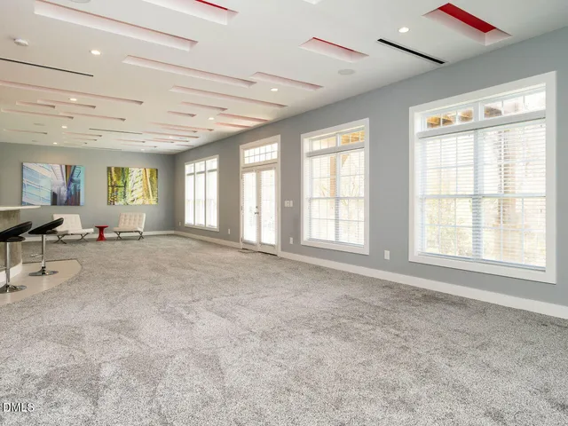 a kitchen with stainless steel appliances granite countertop a red stove and cabinets