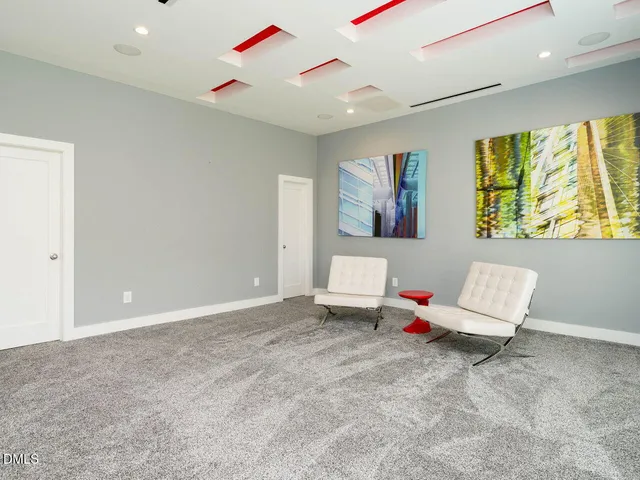 a room with gym equipment and wooden floor