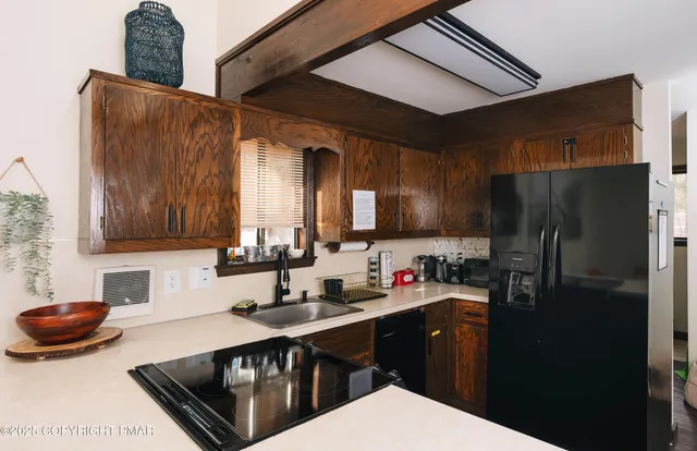 a bedroom with two beds and a chair