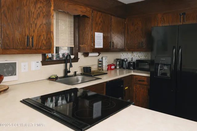 a bedroom with two beds and a desk