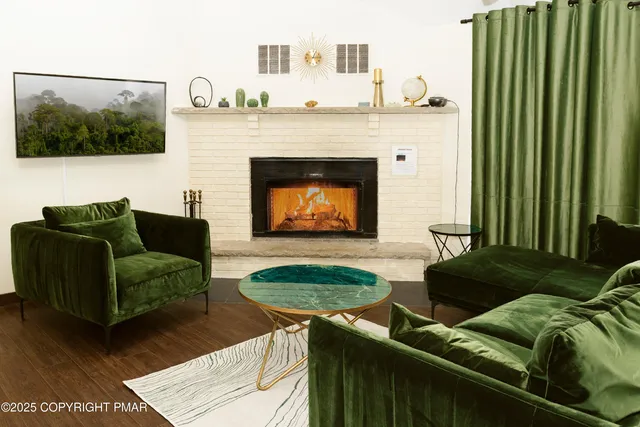 a living room with furniture and a fireplace