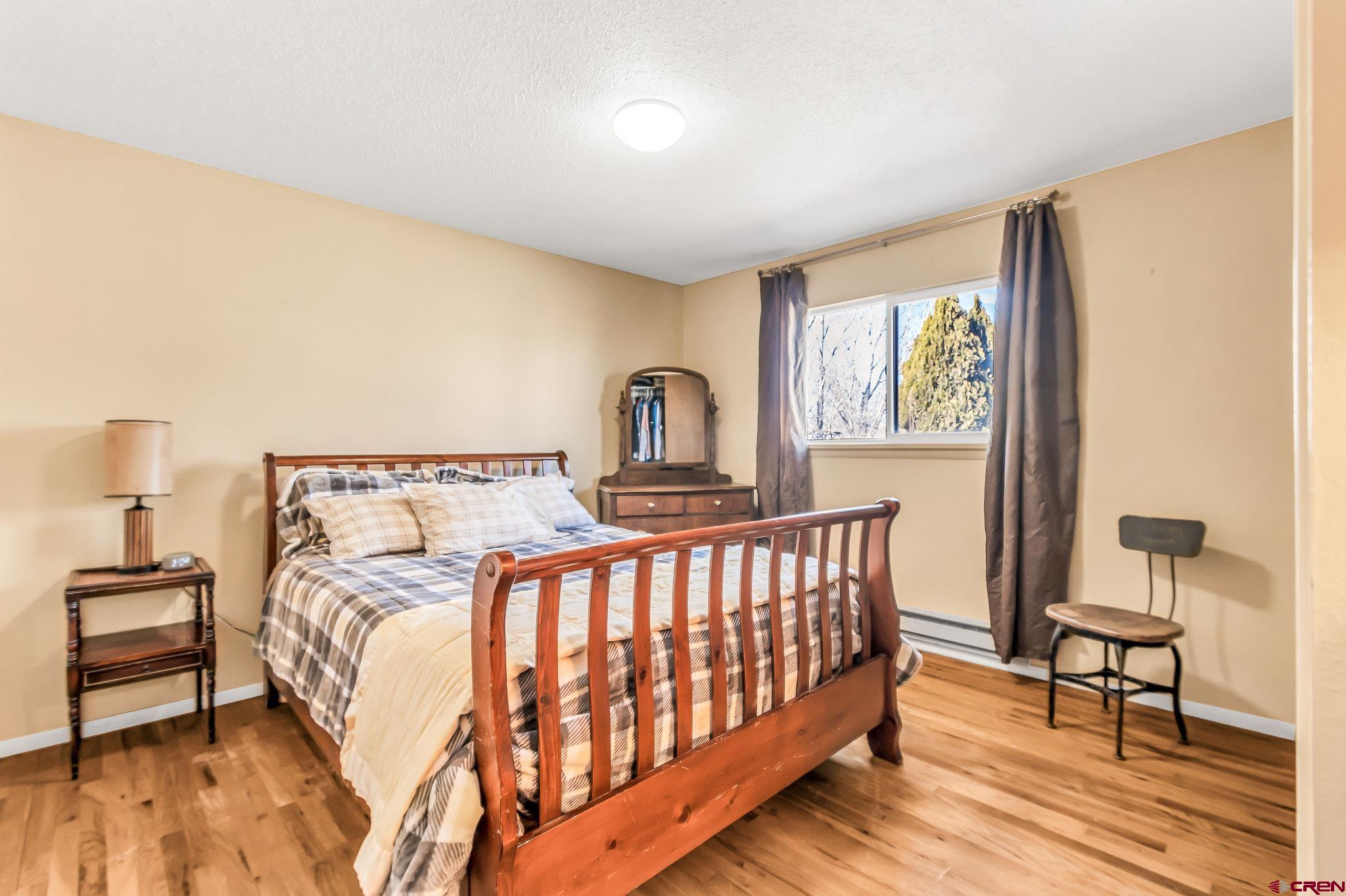 15098 6160th Road Montrose, CO 81403 - Photo 13 of 30 a bedroom with a bed and a window