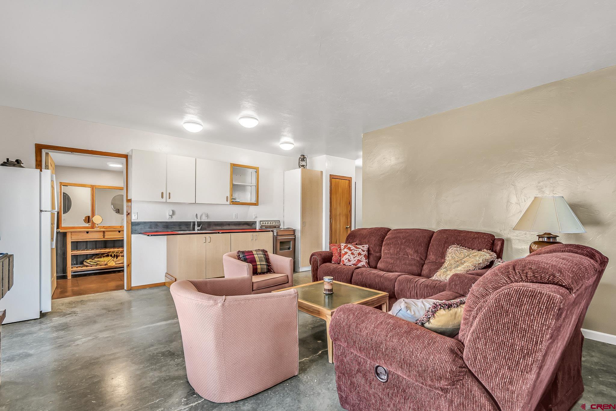 15098 6160th Road Montrose, CO 81403 - Photo 21 of 30 a living room with furniture and kitchen view