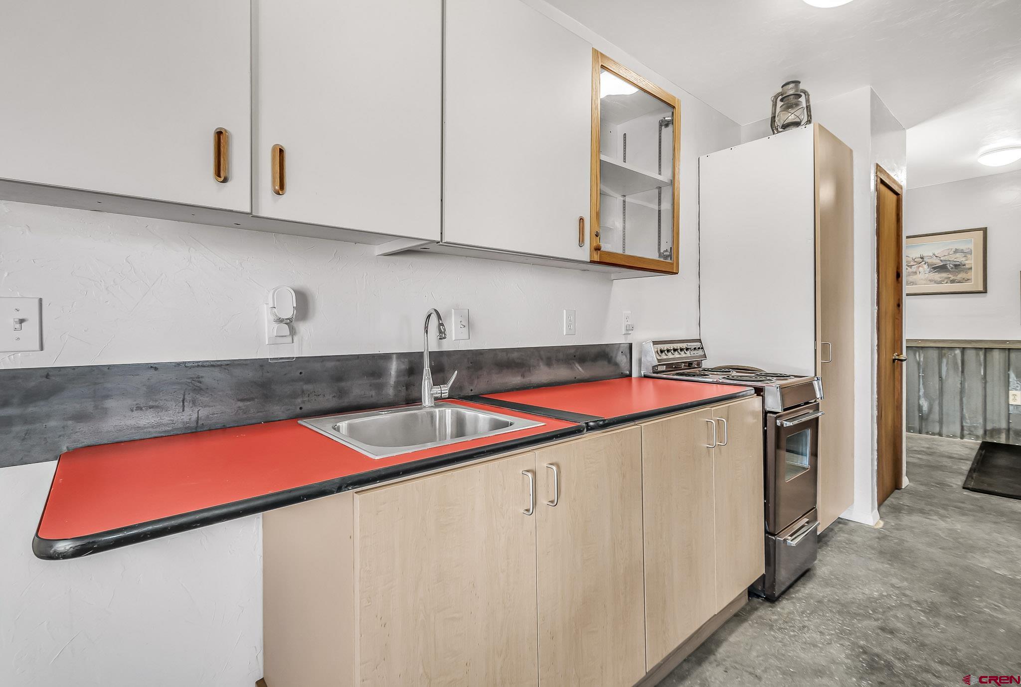 15098 6160th Road Montrose, CO 81403 - Photo 23 of 30 a kitchen with stainless steel appliances granite countertop a sink and a white cabinets