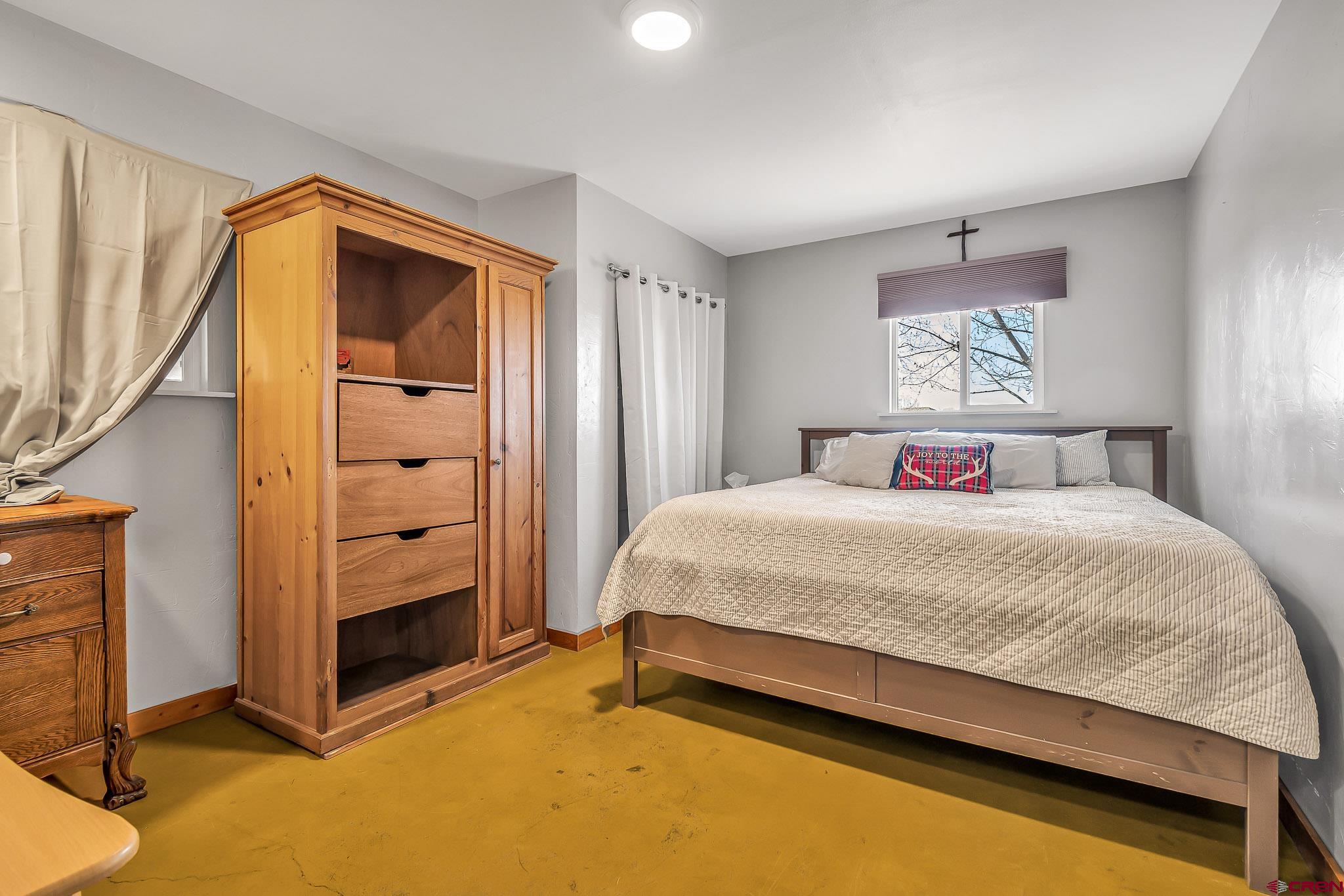 15098 6160th Road Montrose, CO 81403 - Photo 24 of 30 a spacious bedroom with a bed and a window