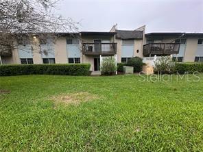 1695 Lee Road, Unit C110 Winter Park, FL 32789 - Photo 2 of 12 a front view of a house with a yard