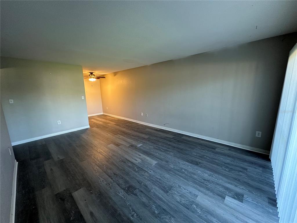 1695 Lee Road, Unit C110 Winter Park, FL 32789 - Photo 5 of 16 an empty room with wooden floor and windows