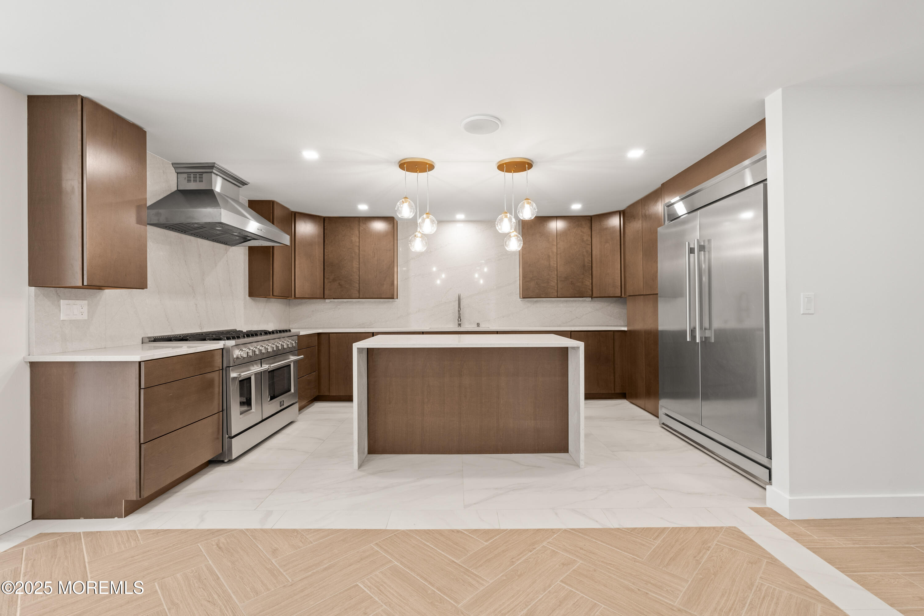 441 Slocum Place Oakhurst, NJ 07755 - Photo 12 of 61 a large kitchen with a large counter top stainless steel appliances and cabinets