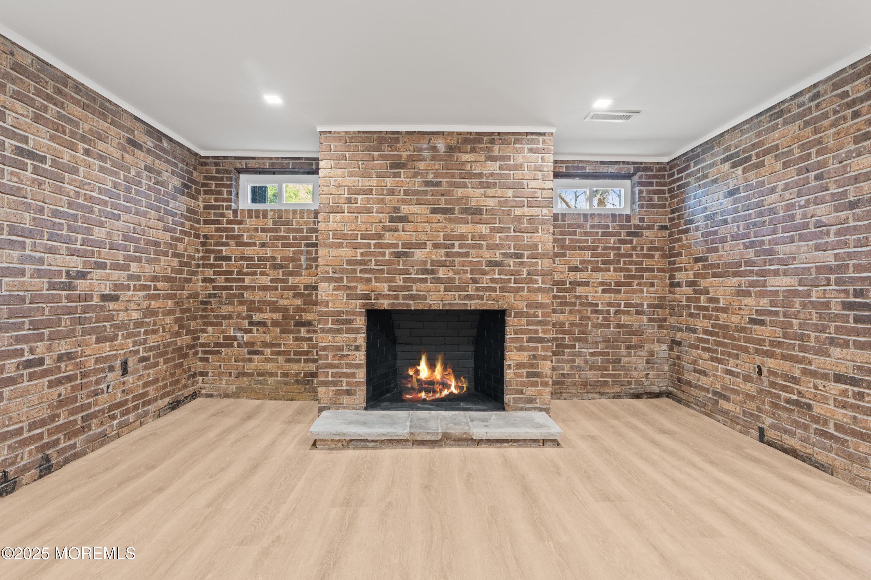 441 Slocum Place Oakhurst, NJ 07755 - Photo 44 of 61 a room with a brick wall and a fireplace