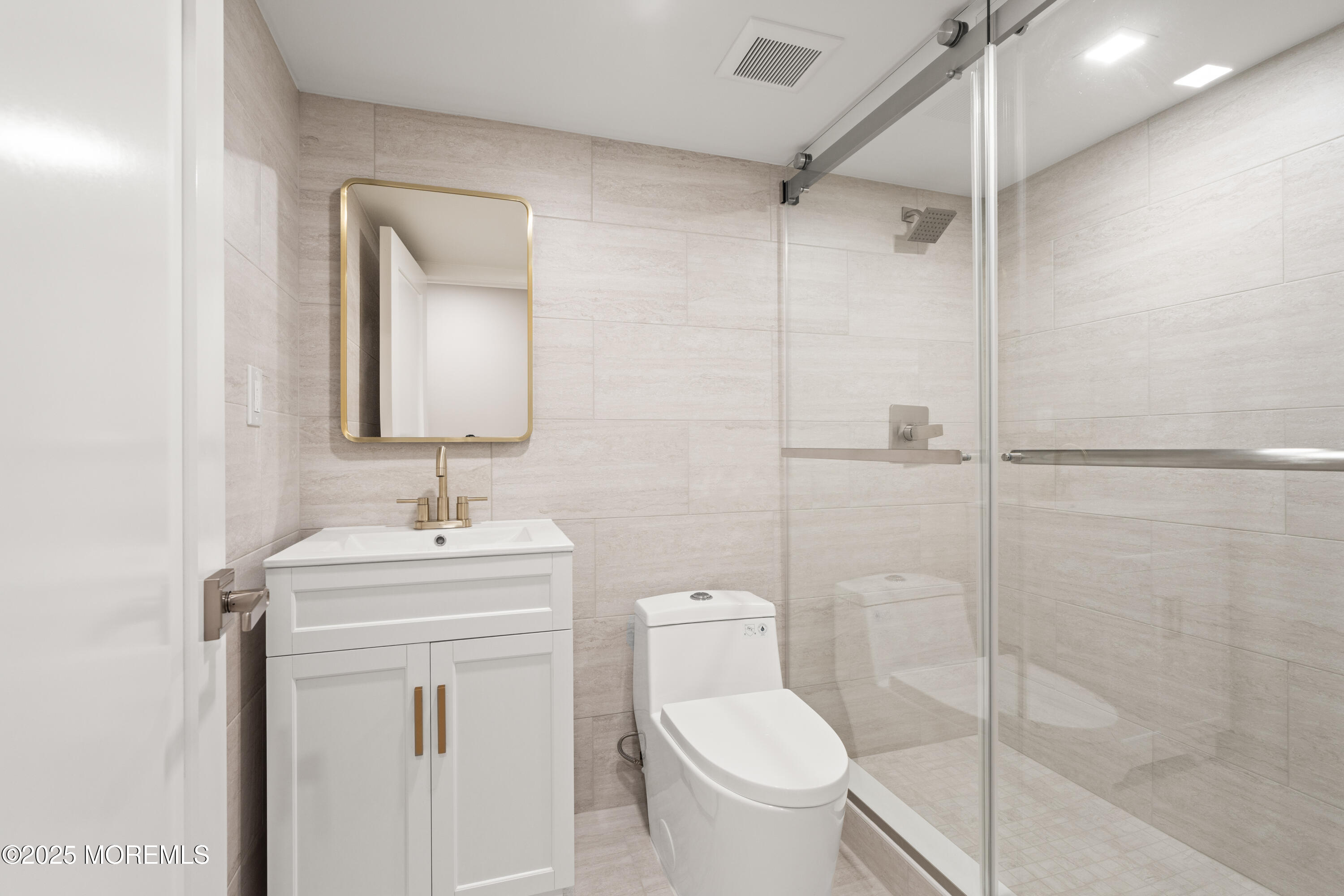 441 Slocum Place Oakhurst, NJ 07755 - Photo 46 of 61 a bathroom with a toilet sink vanity and mirror