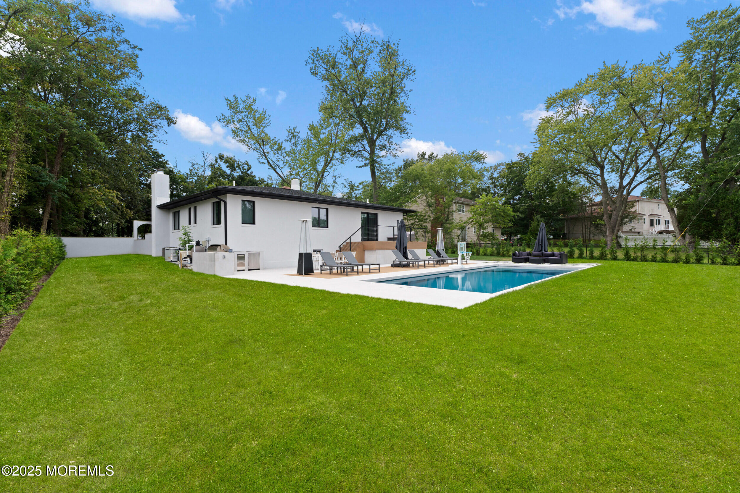 441 Slocum Place Oakhurst, NJ 07755 - Photo 55 of 61 a swimming pool with outdoor seating and yard