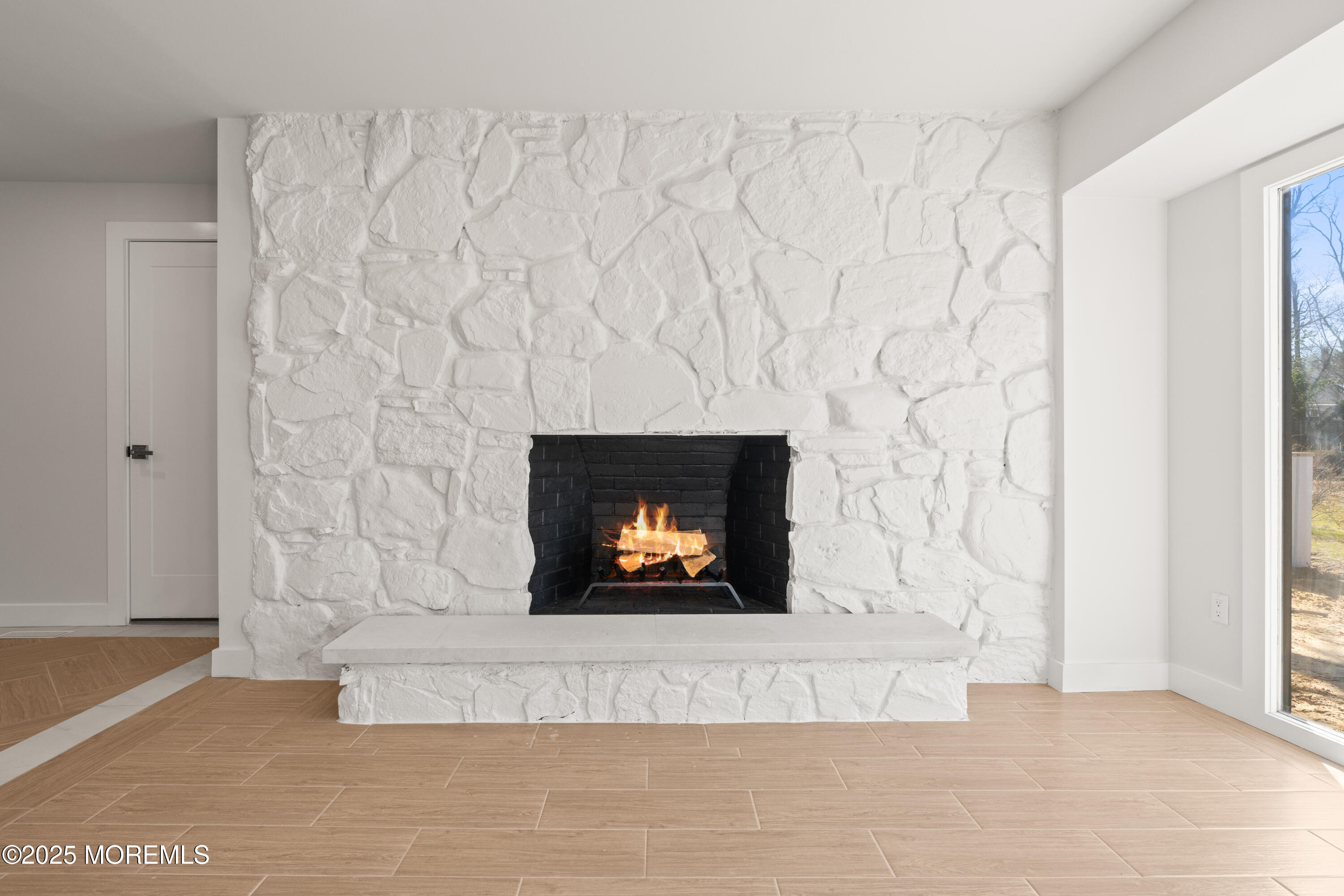 441 Slocum Place Oakhurst, NJ 07755 - Photo 10 of 61 a living room with a fireplace and a flat screen tv