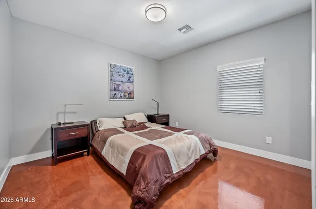 a bed sitting in a bedroom next to a window