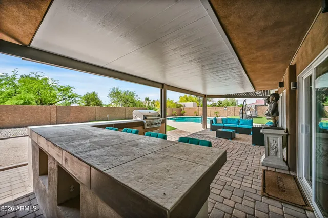 a view of yard from deck with patio