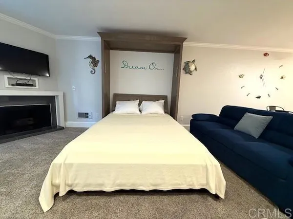 a spacious bedroom with a bed and a flat screen tv