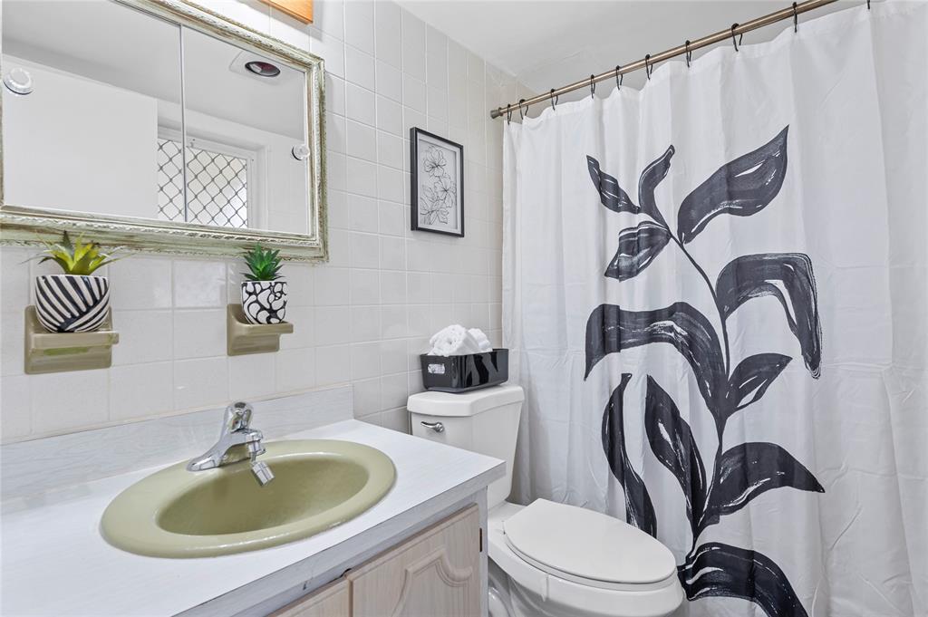 1230 Old Boynton Road, Unit 203 Boynton Beach, FL 33426 - Photo 13 of 25 a bathroom with a sink a mirror and a toilet