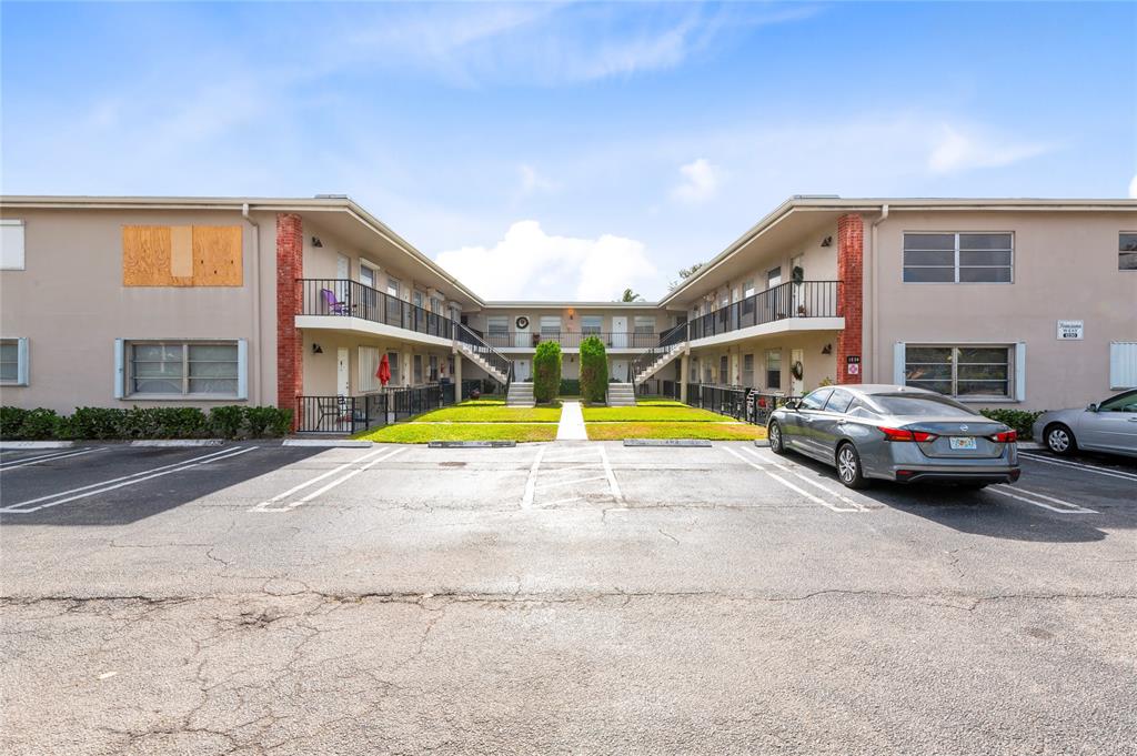 1230 Old Boynton Road, Unit 203 Boynton Beach, FL 33426 - Photo 18 of 25 a view of pool with umbrella and car parked
