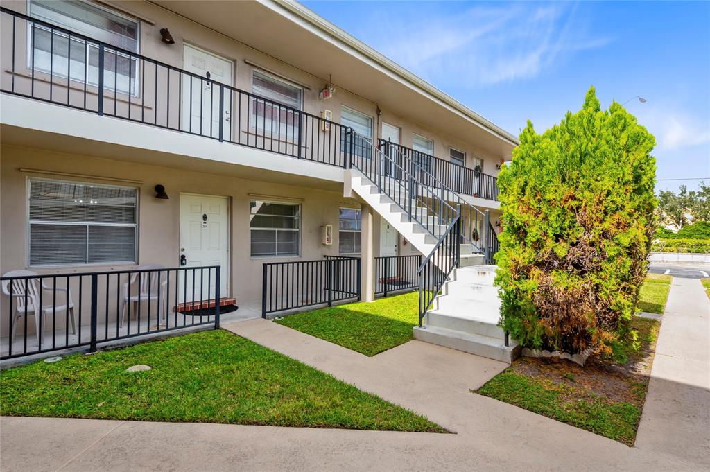 1230 Old Boynton Road, Unit 203 Boynton Beach, FL 33426 - Photo 22 of 25 a view of a house with a yard