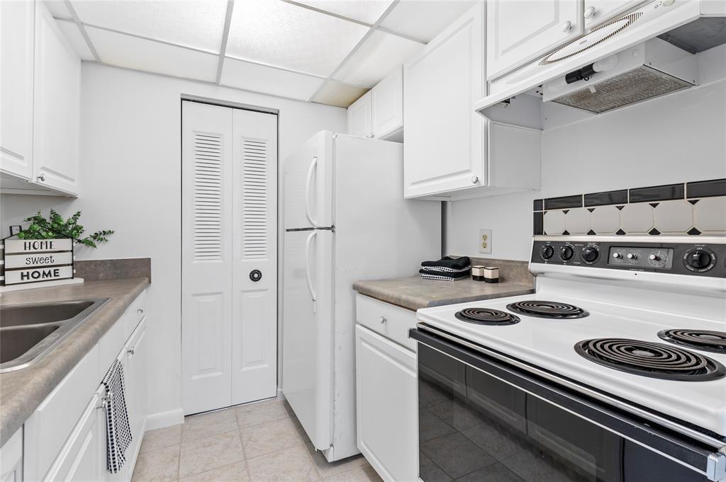 1230 Old Boynton Road, Unit 203 Boynton Beach, FL 33426 - Photo 5 of 25 a kitchen with stainless steel appliances granite countertop a stove and a sink