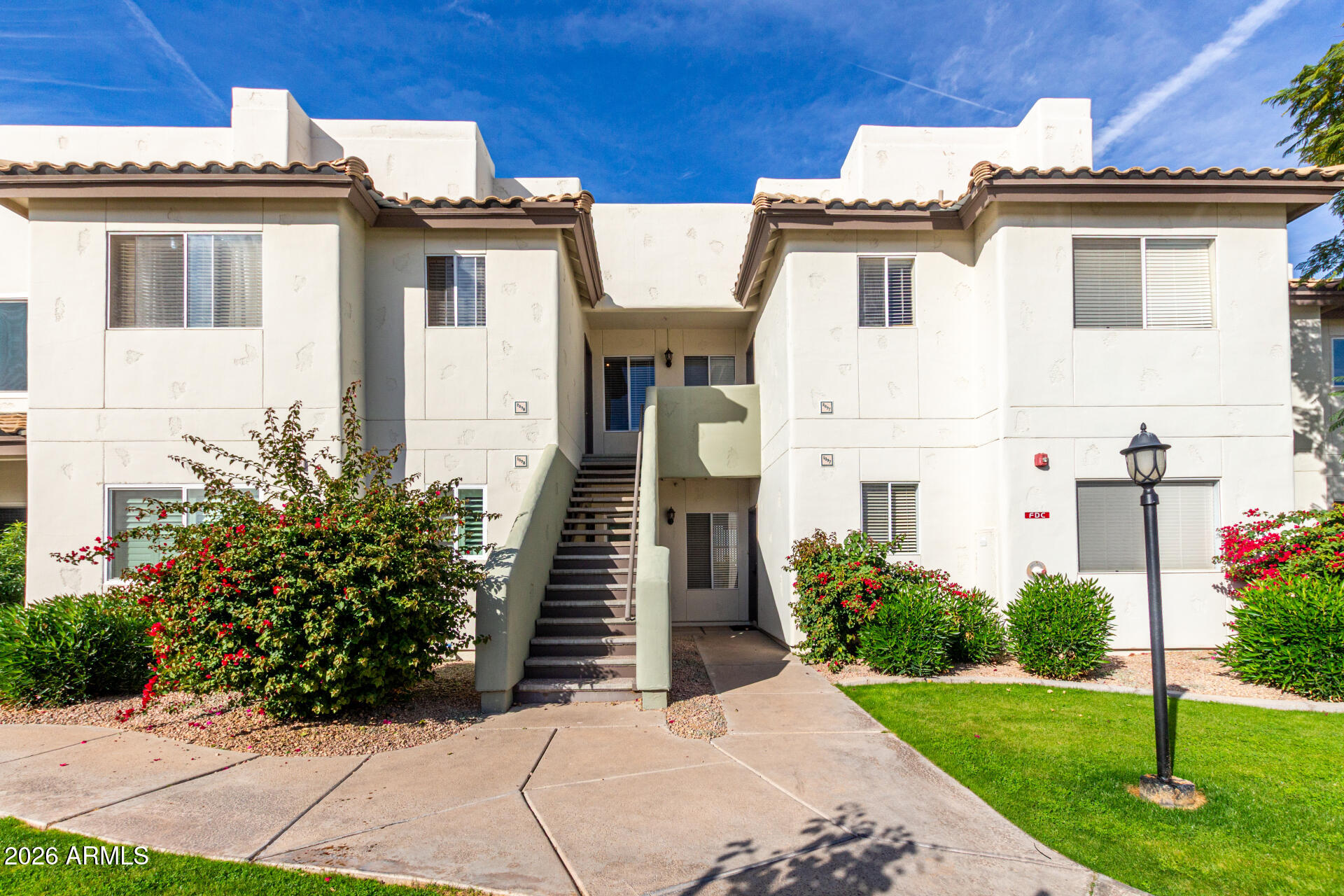 1825 West Ray Road, Unit 2098 Chandler, AZ 85224 - Photo 1 of 30 a view of a white building among the tall windows