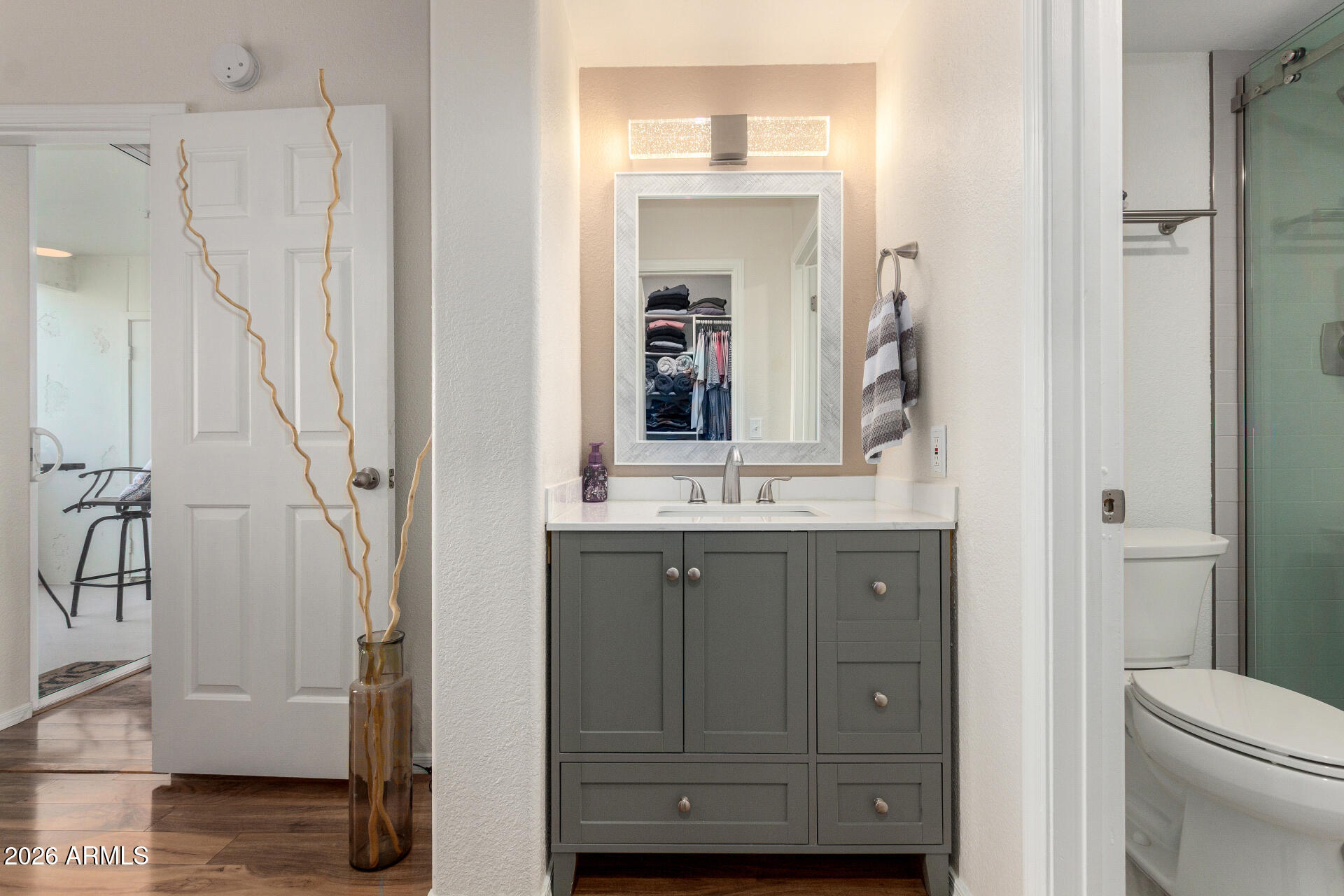 1825 West Ray Road, Unit 2098 Chandler, AZ 85224 - Photo 12 of 30 a bathroom with a granite countertop sink a toilet and a mirror