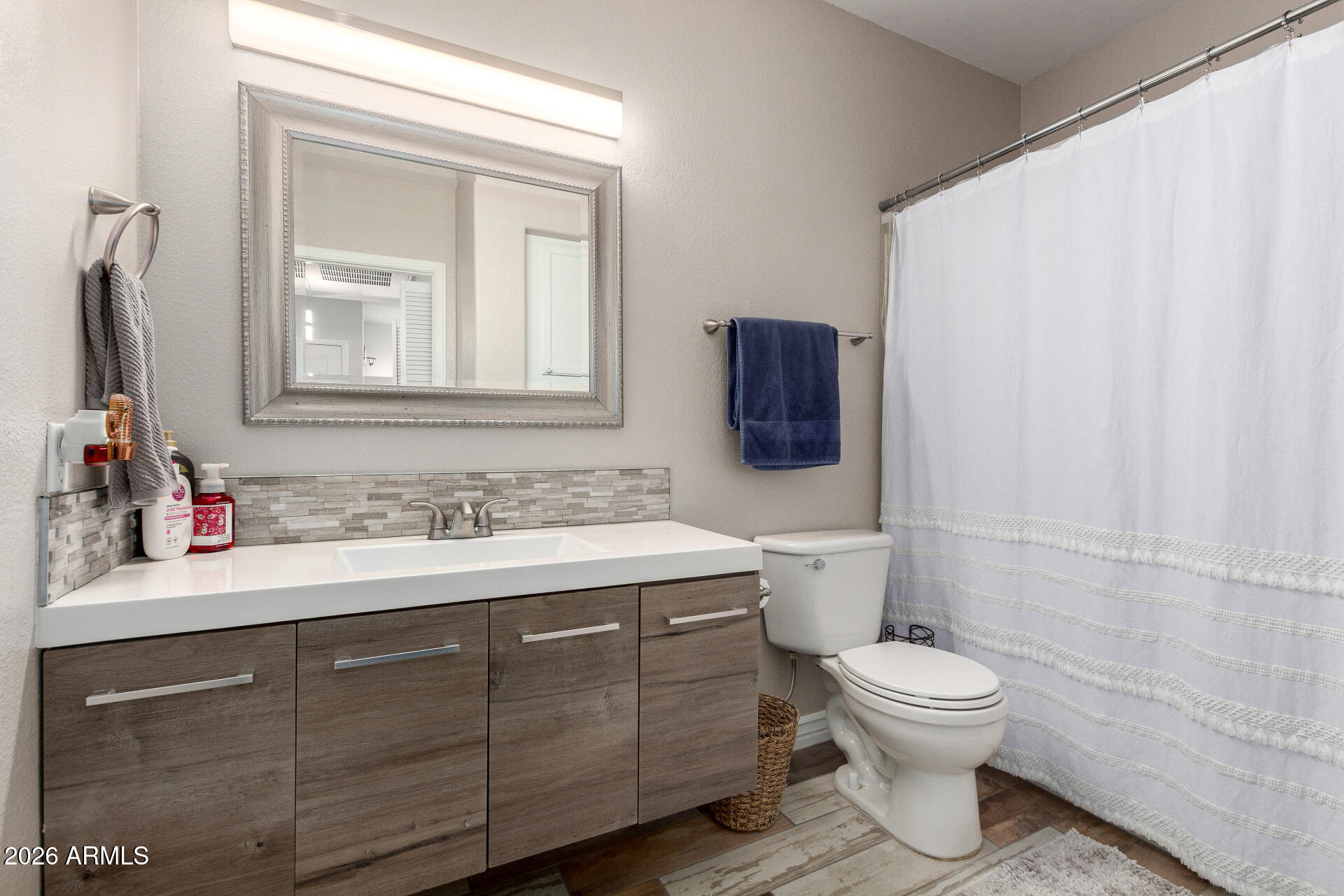 1825 West Ray Road, Unit 2098 Chandler, AZ 85224 - Photo 15 of 30 a bathroom with a toilet sink and mirror