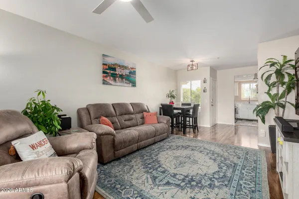 a living room with furniture and wooden floor