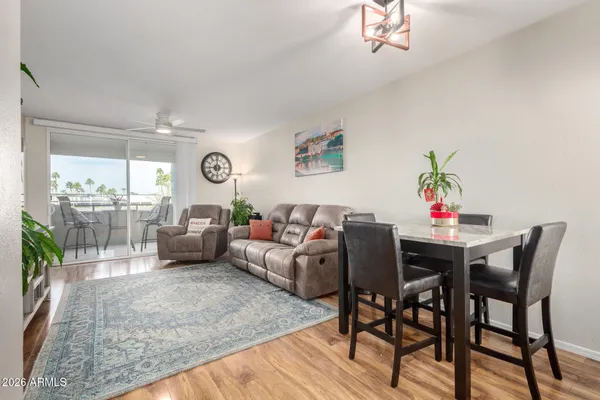 a living room with furniture and a wooden floor